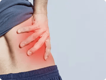 A person clutching their lower back, with a red area highlighting pain or discomfort in the lower back or hip region, possibly indicating a personal injury that may require consultation with a personal injury attorney.