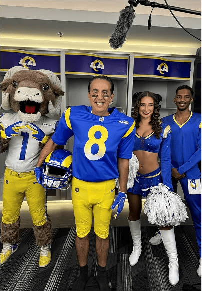 Rams players, cheerleaders, and Rampage together in a locker room