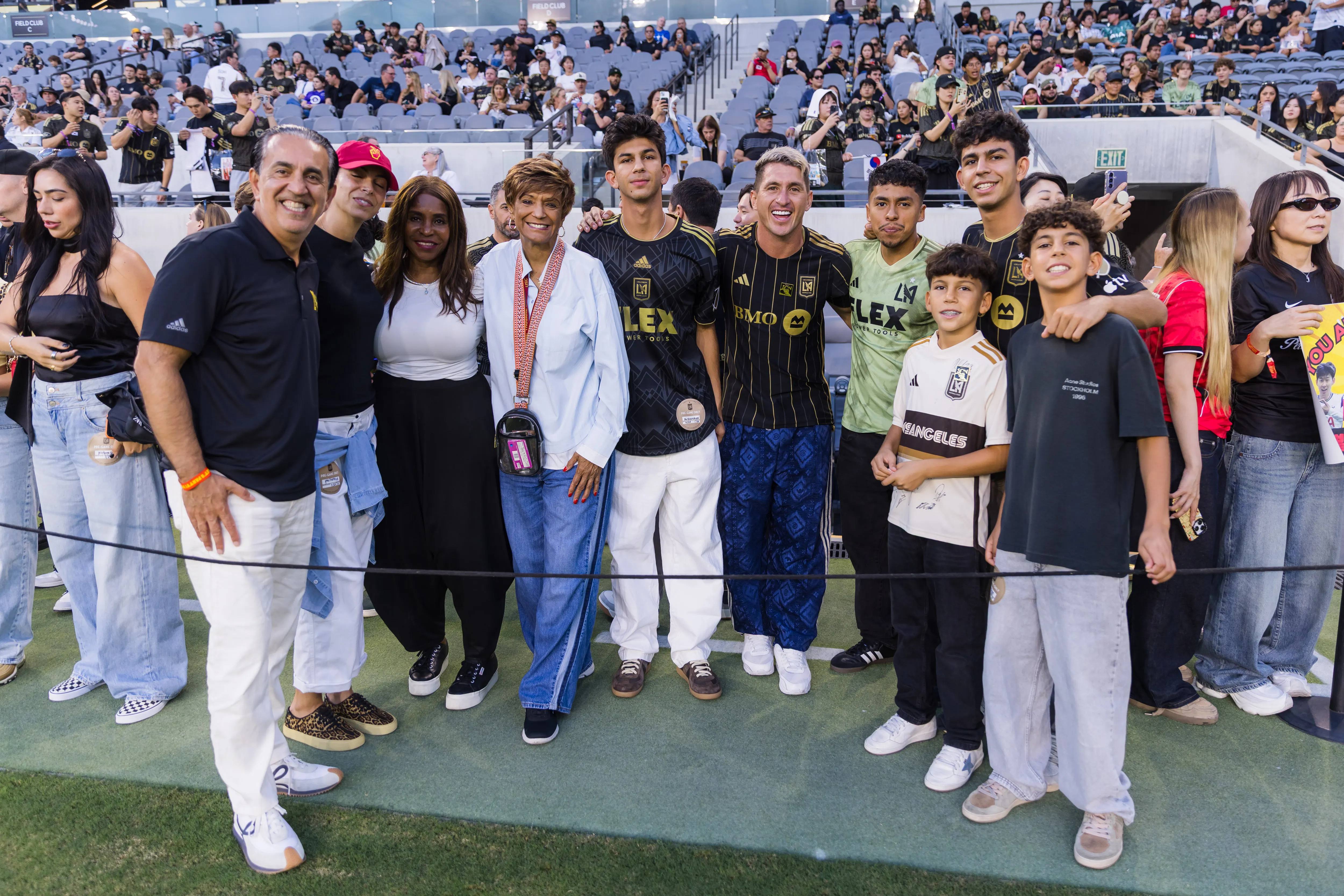 Jacob Emrani poses with LAFC fans and community members at BMO Stadium