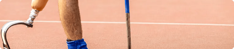 A runner with a prosthetic leg—an inspiration to many who’ve overcome car accidents—stands in a blue athletic shoe on a red running track.