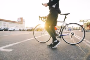 Male Cyclist in street with bicycle