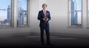 Jacob Emrani speaking in an office overlooking the city
