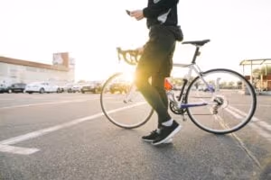 Male Cyclist in street with bicycle