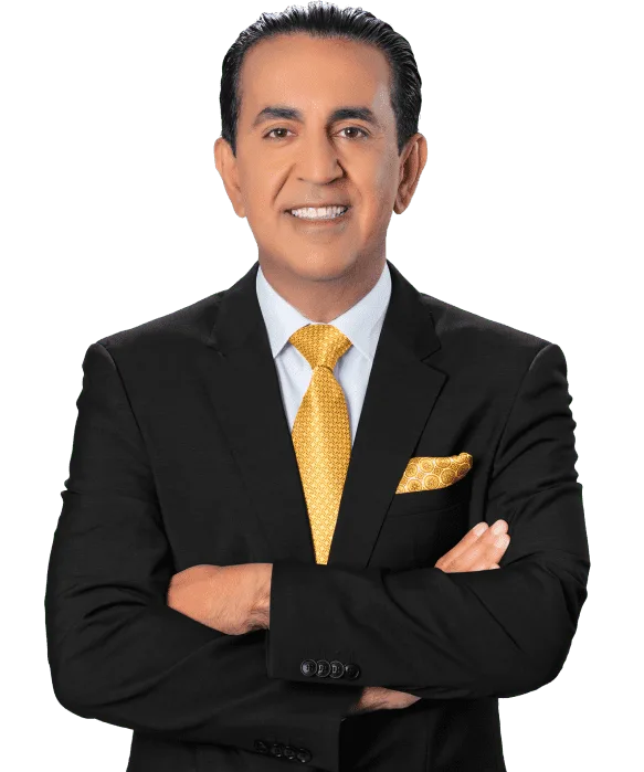 A man wearing a black suit, white shirt, and yellow tie stands with his arms crossed, smiling confidently at the camera—portraying the professionalism of a personal injury attorney against a plain white background.