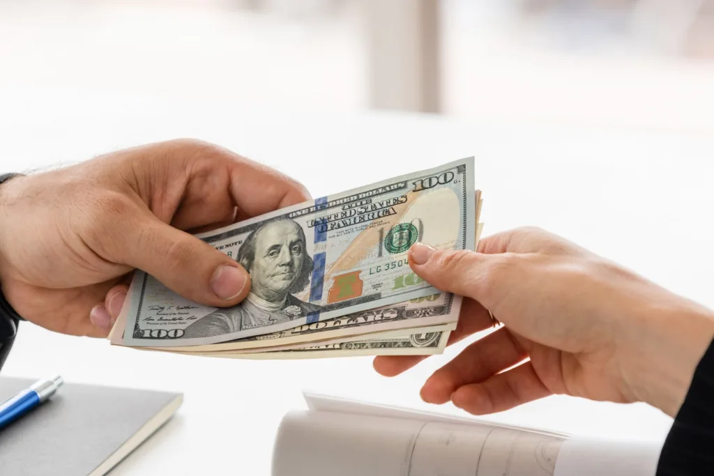 100-hundred-dollar-bills-in-two-hands-settlement