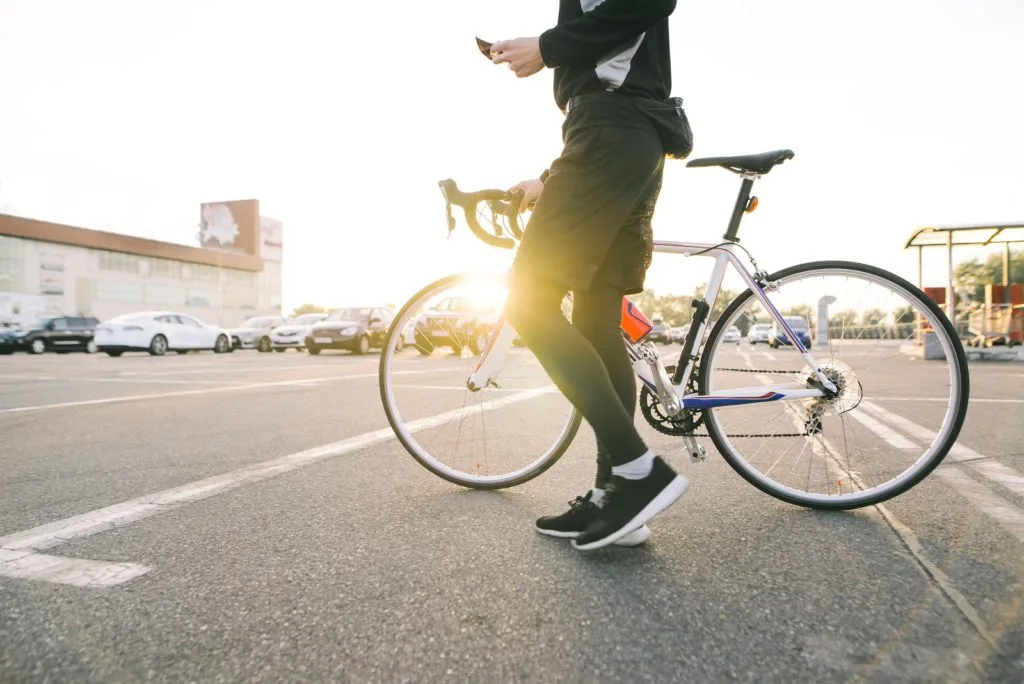 Male Cyclist in street with bicycle