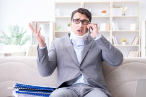 Man-in-neck-brace-talking-on-phone-to-personal-injury-lawyer