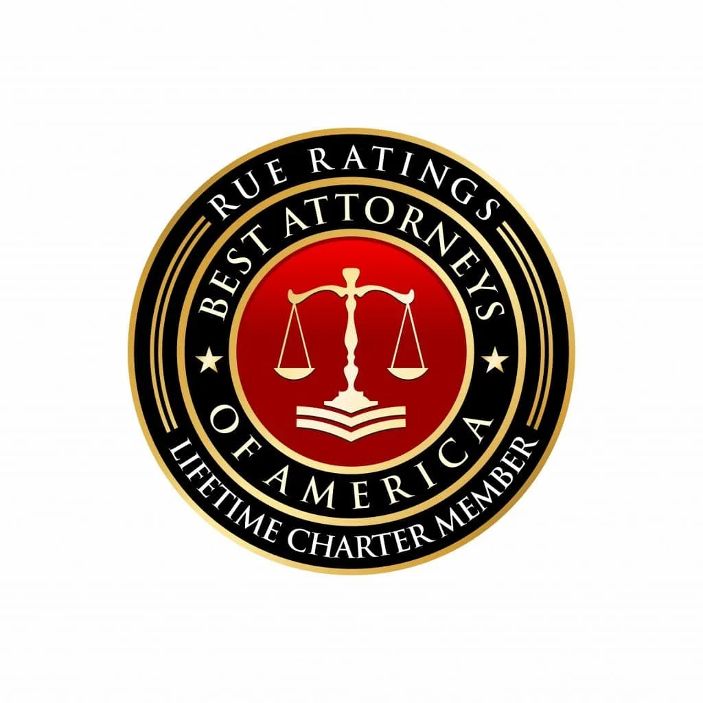 A gold and black circular badge with a red center featuring the scales of justice, books, and the text: "Rue Ratings Best Attorneys of America Lifetime Charter Member," honoring top personal injury attorneys and lawyers for car accidents.