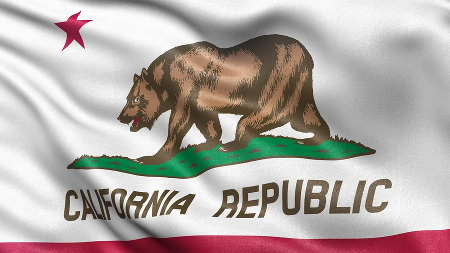 The California state flag features a grizzly bear walking on grass, a red star in the top left, and "California Republic" below—an emblem often seen in personal injury attorney offices helping those involved in car accidents across the state.