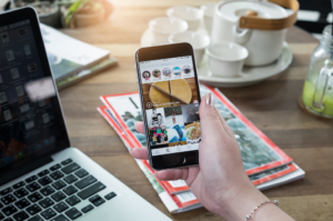 browsing instagram on phone at desk