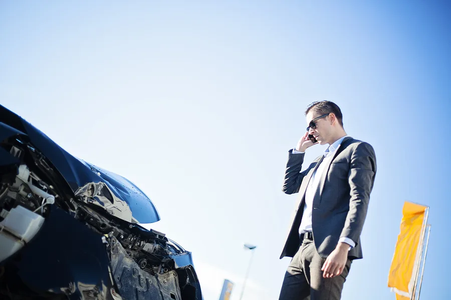 man-looking-at-crashed-car