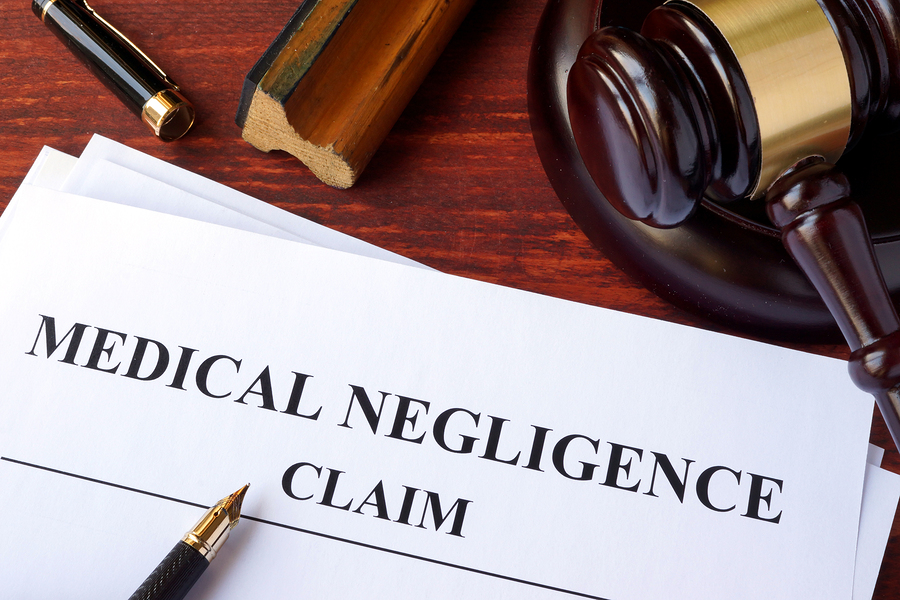 Medical Negligence claim and gavel on a table.