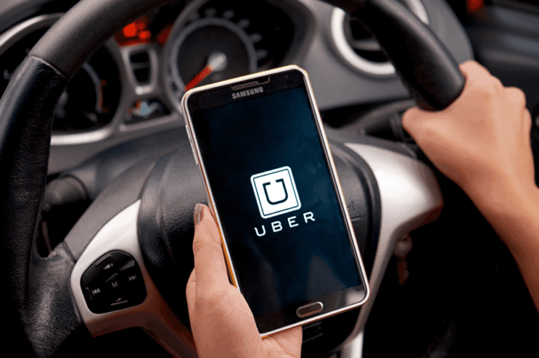 driver using Uber app on phone