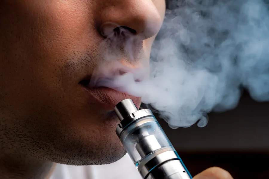 man vaping with e-cigarette