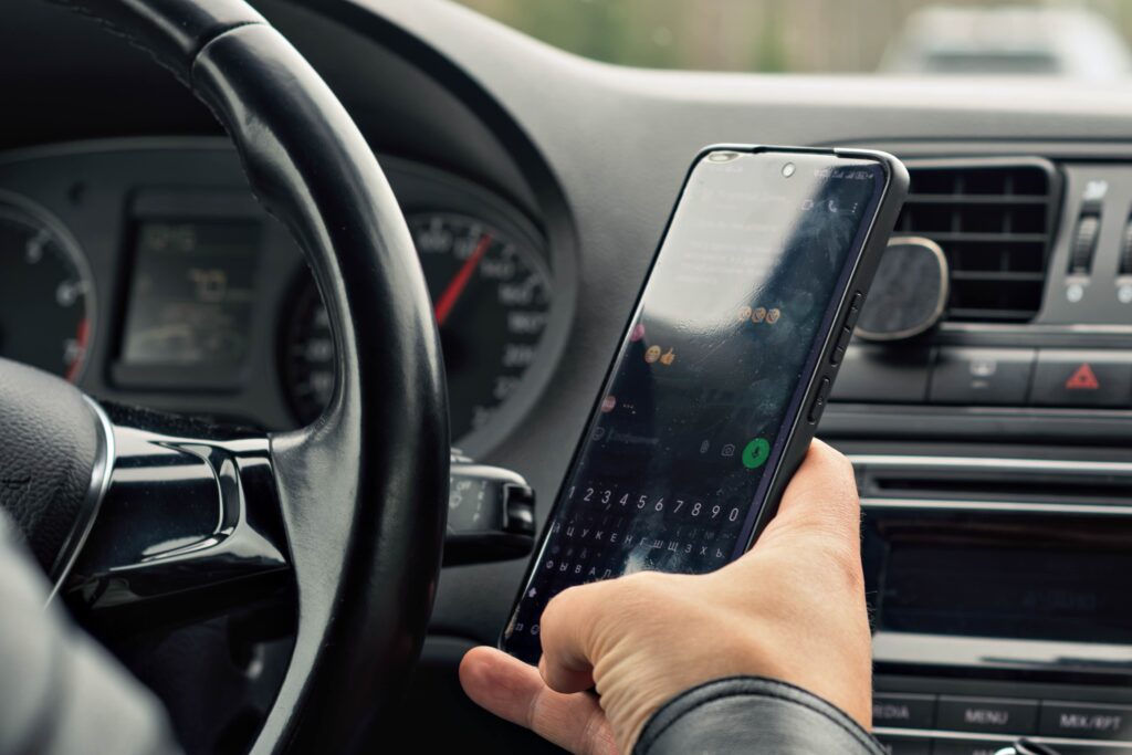 New California Traffic Laws in 2025. Driver types on smartphone while driving.