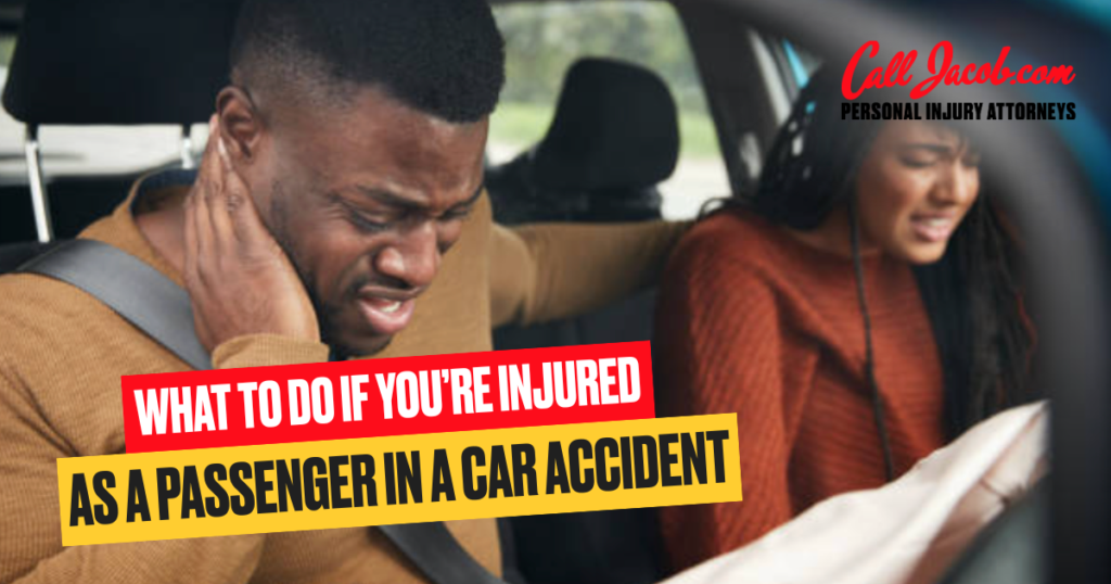 A man and woman sit in a car after an accident, both appearing distressed. The man holds his neck in pain while the woman grips her arm. Text reads: “What to do if you’re injured as a passenger in a car accident.”.