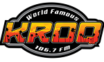 Logo for KROQ 106.7 FM with the words "World Famous" above large orange and yellow "KROQ" lettering, featuring a city skyline and star details inside the letters.