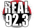 The logo for radio station Real 92.3 features bold, distressed white text reading "REAL 92.3" against a red and black circular background.